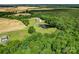 Breathtaking aerial view of a stunning property including home, pond, and surrounding acreage at 4111 Jenkins Rd, Marshville, NC 28103