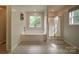 Bright bathroom with a soaking tub, glass-enclosed shower, and a large window offering natural light and views at 4111 Jenkins Rd, Marshville, NC 28103
