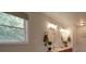 Bright bathroom featuring a double vanity, decorative mirrors, and natural light from the window at 4111 Jenkins Rd, Marshville, NC 28103