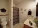 Cozy bathroom featuring a patterned shower curtain, a vanity with ample storage, and a functional toilet at 4111 Jenkins Rd, Marshville, NC 28103