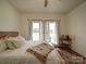 Bright bedroom with hardwood floors, a comfortable bed, and views from the windows, creating a peaceful atmosphere at 4111 Jenkins Rd, Marshville, NC 28103