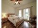 Bright bedroom featuring a wooden bed, bedside table, ceiling fan, and natural light at 4111 Jenkins Rd, Marshville, NC 28103