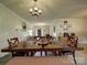 Spacious dining room featuring a large wooden table, seating for eight, and an elegant chandelier, perfect for gatherings at 4111 Jenkins Rd, Marshville, NC 28103