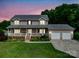 Charming two-story home with a welcoming front porch, well-manicured lawn, and three car garage at 4111 Jenkins Rd, Marshville, NC 28103