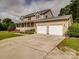 Beautiful home featuring a covered porch, landscaping, and a spacious three car driveway at 4111 Jenkins Rd, Marshville, NC 28103