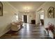 Inviting foyer with wood-look flooring, decor accents, and comfortable seating area; the entryway creates a warm welcome at 4111 Jenkins Rd, Marshville, NC 28103