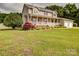Charming home boasts a large front porch, well-manicured lawn, and beautiful landscaping at 4111 Jenkins Rd, Marshville, NC 28103