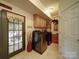 Functional laundry room with modern washer and dryer, cabinets, and access to the outdoors at 4111 Jenkins Rd, Marshville, NC 28103