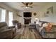 Cozy living room featuring a fireplace, TV, modern ceiling fan, and comfortable seating at 4111 Jenkins Rd, Marshville, NC 28103