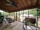 Enclosed porch features comfortable seating, wooden flooring and screened windows at 4111 Jenkins Rd, Marshville, NC 28103