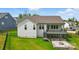 Beautifully landscaped backyard features a spacious deck, a stone patio, and a cozy fire pit at 4116 Spring Cove Way, Belmont, NC 28012