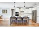 A modern kitchen island featuring barstool seating, pendant lighting, and hardwood floors at 4116 Spring Cove Way, Belmont, NC 28012
