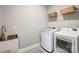Laundry room featuring stainless steel sink and modern washer and dryer at 4116 Spring Cove Way, Belmont, NC 28012