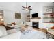 Spacious living room with a fireplace, built-in shelves, and hardwood floors at 4116 Spring Cove Way, Belmont, NC 28012