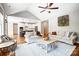 Bright living room featuring hardwood floors, a ceiling fan and opens to a modern kitchen at 4116 Spring Cove Way, Belmont, NC 28012