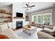 Spacious living room features a fireplace, built-in shelves, large windows, and natural light at 4116 Spring Cove Way, Belmont, NC 28012