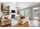Bright living room with fireplace, built-in shelves, hardwood floors, and large windows at 4116 Spring Cove Way, Belmont, NC 28012