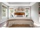 Bright main bedroom featuring a decorative headboard, bedside tables and two windows at 4116 Spring Cove Way, Belmont, NC 28012