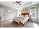Bright main bedroom featuring a decorative headboard, bedside tables and two windows at 4116 Spring Cove Way, Belmont, NC 28012