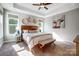 Bright main bedroom featuring a decorative headboard, bedside tables and two windows at 4116 Spring Cove Way, Belmont, NC 28012