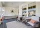 Inviting front porch features brick accents, rocking chairs, and neutral outdoor rug at 4116 Spring Cove Way, Belmont, NC 28012