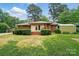 Charming home with a lush, green backyard, deck, and storage shed at 4220 Castlewood Rd, Charlotte, NC 28209