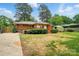 A well-maintained backyard features a deck, storage shed, and mature trees at 4220 Castlewood Rd, Charlotte, NC 28209