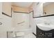 Updated bathroom with stylish fixtures, a shower and bathtub combination, and black and white accents at 4220 Castlewood Rd, Charlotte, NC 28209