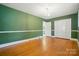 Green bedroom with natural light and hardwood floors at 4220 Castlewood Rd, Charlotte, NC 28209