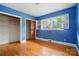 Blue bedroom with natural light and hardwood floors at 4220 Castlewood Rd, Charlotte, NC 28209