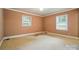 Cozy bedroom features neutral walls and two windows at 4220 Castlewood Rd, Charlotte, NC 28209
