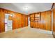Bonus room with natural wood paneling and built-in shelves; open to the kitchen at 4220 Castlewood Rd, Charlotte, NC 28209