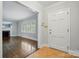 Bright foyer leading to living room with hardwood floors and fireplace; tiled entry floor at 4220 Castlewood Rd, Charlotte, NC 28209