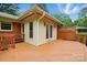 An exterior view of back deck and sunroom with wooden railing detail at 4220 Castlewood Rd, Charlotte, NC 28209