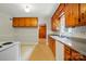 Cozy kitchen features wooden cabinets, a white appliance suite, and ample counter space at 4220 Castlewood Rd, Charlotte, NC 28209