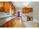 Cozy kitchen features wooden cabinets, a white appliance suite, and ample counter space at 4220 Castlewood Rd, Charlotte, NC 28209