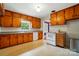 Cozy kitchen features wooden cabinets, a white appliance suite, and ample counter space at 4220 Castlewood Rd, Charlotte, NC 28209