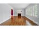 Spacious living room with hardwood floors, fireplace, and large window with plantation shutters at 4220 Castlewood Rd, Charlotte, NC 28209
