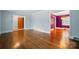 Open living room with hardwood floors transitioning to dining area with unique light fixture at 4220 Castlewood Rd, Charlotte, NC 28209