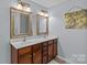 Bathroom boasts double sinks with gorgeous framed mirrors, cabinet storage, and great lighting at 4531 Dalbeth St, Charlotte, NC 28213