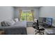 Relaxing bedroom featuring a bed near a window, and a computer desk setup with natural light at 4531 Dalbeth St, Charlotte, NC 28213