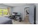 Comfortable bedroom with a computer desk setup and a view to the hallway and a bed at 4531 Dalbeth St, Charlotte, NC 28213