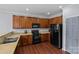 Functional kitchen with wood cabinets and modern appliances at 4531 Dalbeth St, Charlotte, NC 28213