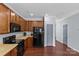 Well-equipped kitchen boasting wooden cabinets, black appliances, and hardwood floors at 4531 Dalbeth St, Charlotte, NC 28213