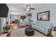 Spacious living area with hardwood floors, comfortable seating, and open layout to dining area at 4531 Dalbeth St, Charlotte, NC 28213