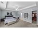 Spacious main bedroom features a tray ceiling, neutral decor, and an attached walk-in closet at 4531 Dalbeth St, Charlotte, NC 28213