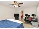 Well-lit bedroom with a ceiling fan, TV, and desk setup; an open doorway leads to the bathroom at 459 Presidents Ct, Charlotte, NC 28217