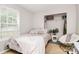 Inviting bedroom with natural light, a plush bed, and a cozy reading chair at 459 Presidents Ct, Charlotte, NC 28217