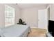 Bedroom features a large window for ample light and neutral tones; bed and desk in the space at 459 Presidents Ct, Charlotte, NC 28217