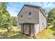 Side view of the home showing the siding, backyard shed, and green lawn at 459 Presidents Ct, Charlotte, NC 28217
